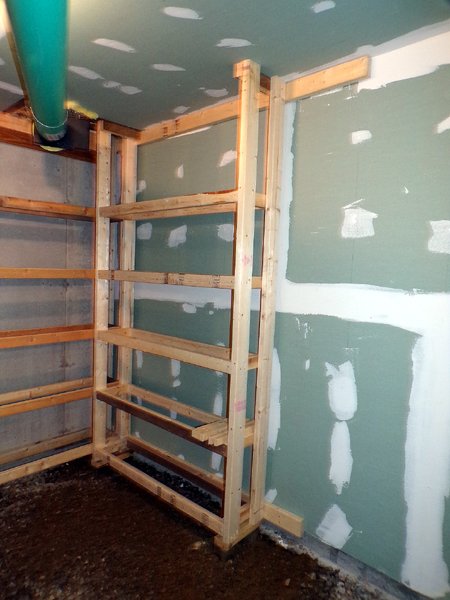 Construction - root cellar - 1st shelving done on east wall crop Feb. 2023.jpg