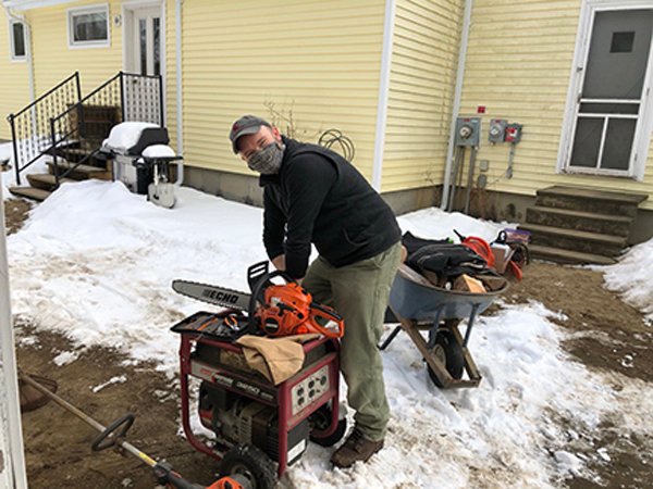 Tom Silliman services the chainsaw Feb. 2021.jpg