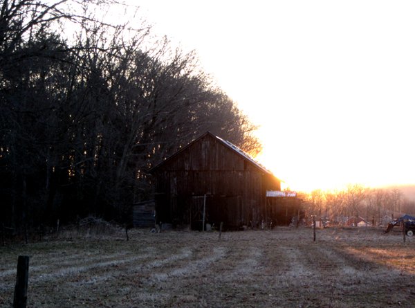Sun coming up behind barn crop March 2025.jpg