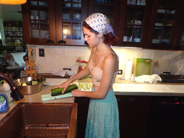 Zucchini ravioli - Phoebe slicing zucchini crop July 2024.jpg