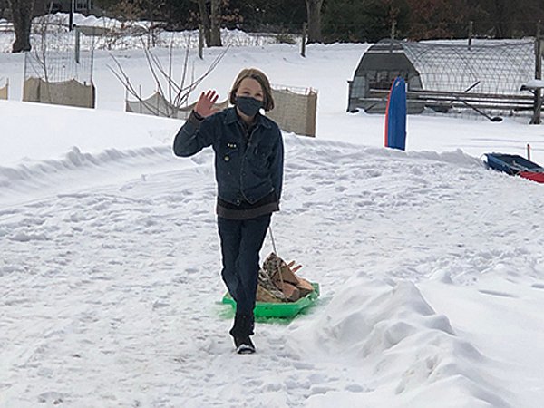 Wiley Silliman hauls wood up the hill Feb. 2021.jpg