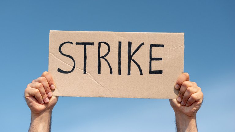 protester-holding-board-with-strike.jpg