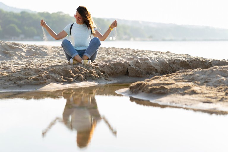 woman-playing-with-sand-beach.jpg