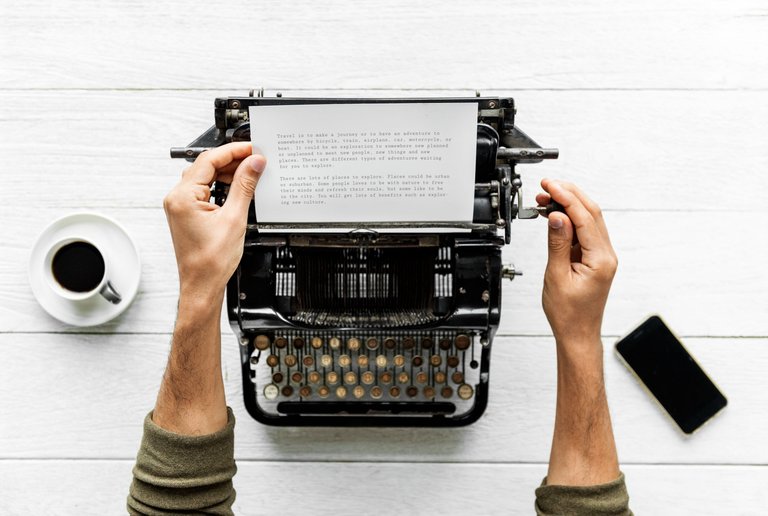 aerial-view-man-typing-retro-typewriter.jpg