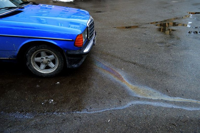 Blue old car leaking its oil, Once upon a time in Romania