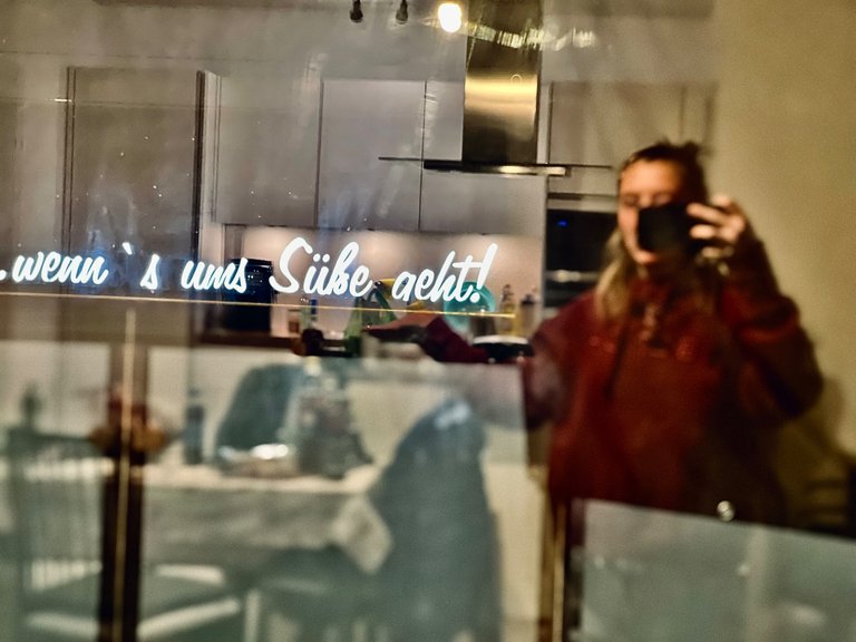 "When it comes to sweetness", Playing with reflected light from the shop signs opposite from where I was hosted, Self Portrait, Vienna, Austria, December 2023