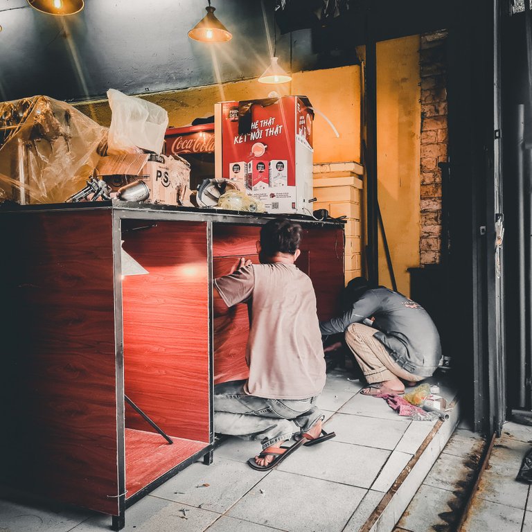 Workers set up the display case for some local goods we will sell.