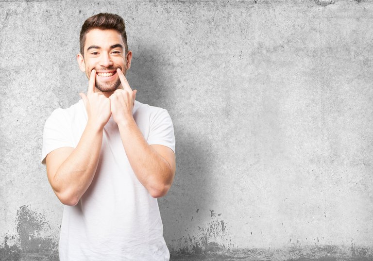 man-marking-his-smile-with-two-fingers.jpg