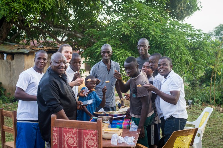 Eating communally at the going-away party before I left Bopolu. Mr. Kamara in the Center, Principal Shariff in Black, Paul on the far left, and some of our students. They are missed.