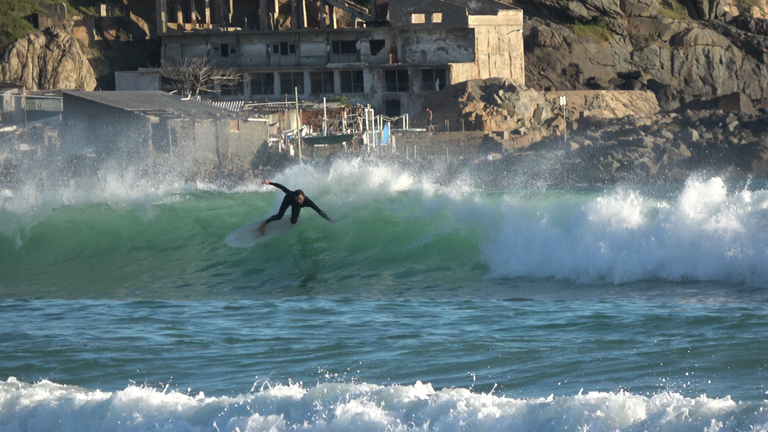 Surfer and shaper Matheus Miranda in a roundhouse cutback at Praia Grande, Arraial do Cabo. by Mariana Brito.