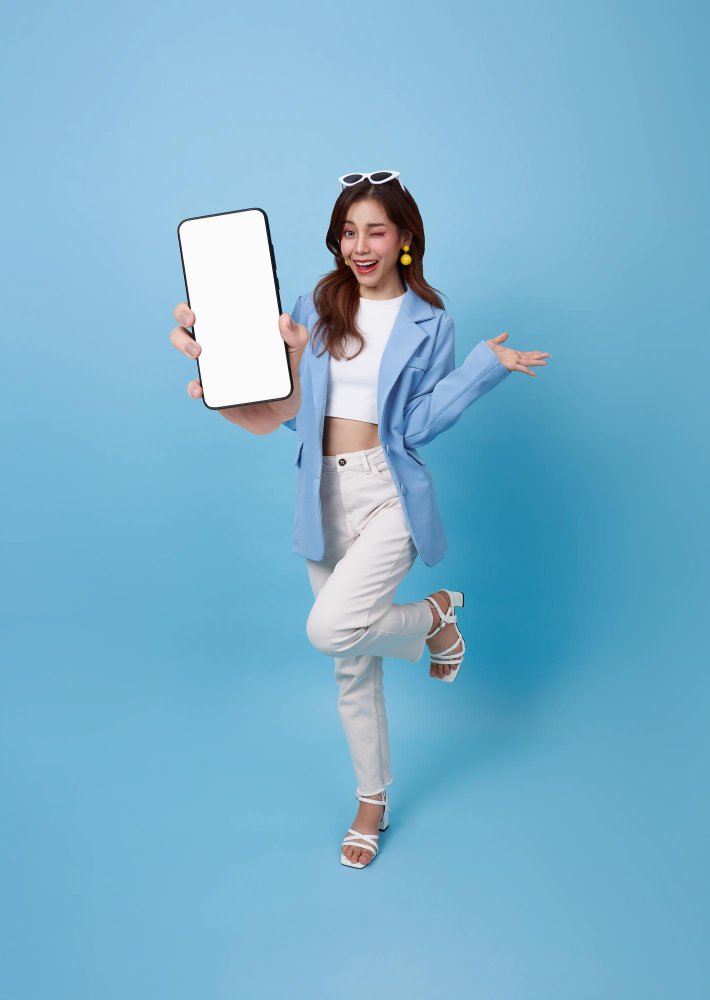 full-length-beautiful-asian-teen-woman-showing-smartphone-mockup-blank-screen-smiling.jpg