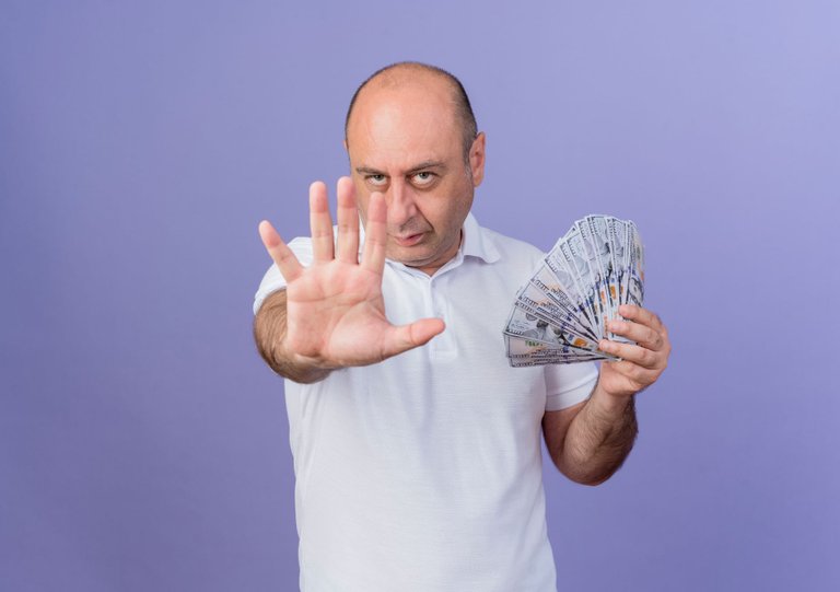 confident-casual-mature-businessman-holding-money-stretching-out-hand-towards-camera-showing-five-with-hand-camera-isolated-purple-background-with-copy-space.jpg