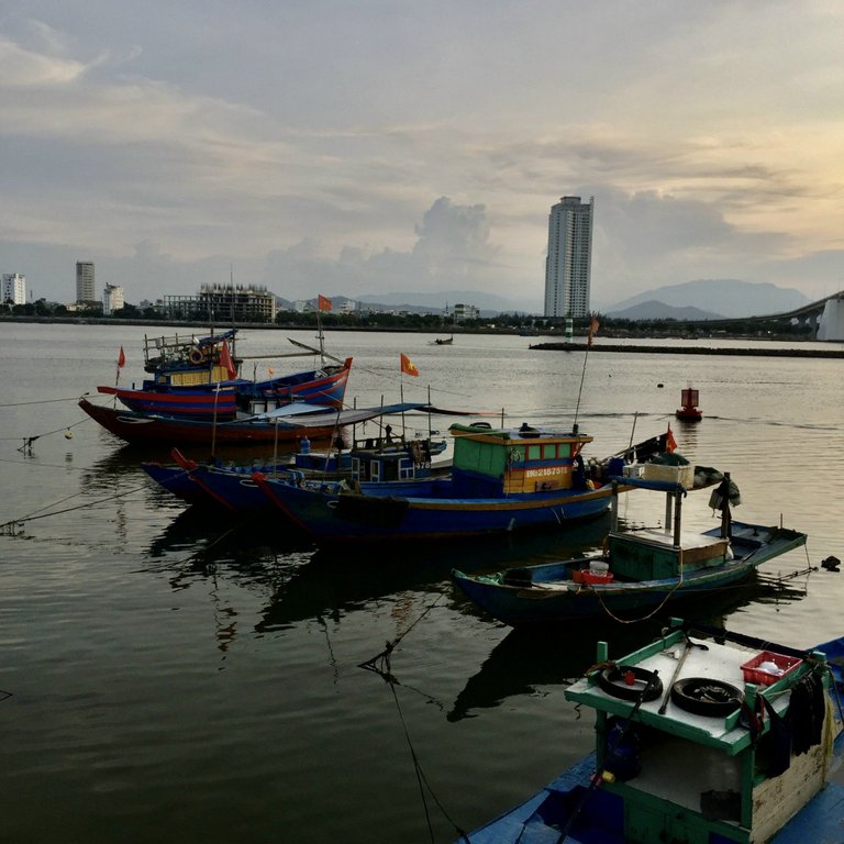 Fishing boats are parked at the foot of Thuan Phuoc bridge