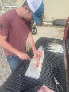 Braxton filleting fish.jpg