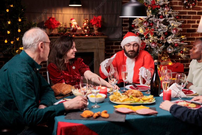 friends-celebrating-christmas-eating-traditional-festive-meal-husband-wearing-santa-claus-costume-wife-chatting-holiday-celebration-people-gathering-drinking-sparkling-wine_482257-50366.jpg