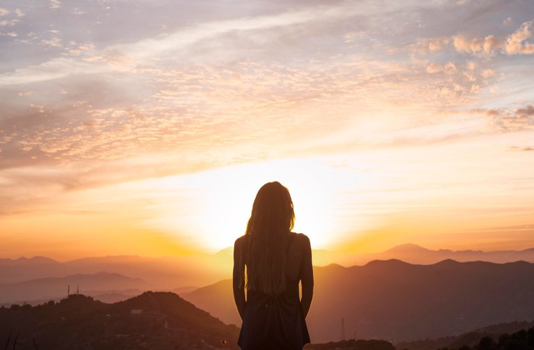 back-view-woman-doing-yoga-while-watching-sunset.jpg