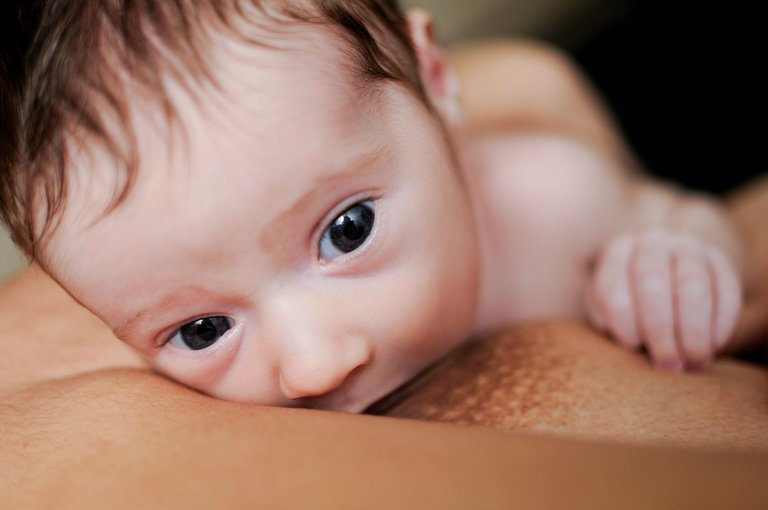 young-mother-breastfeeding-newborn-baby-at-home.jpg
