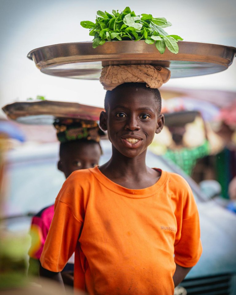 free-photo-of-street-vendor-child-balancing-produce-tray.jpeg