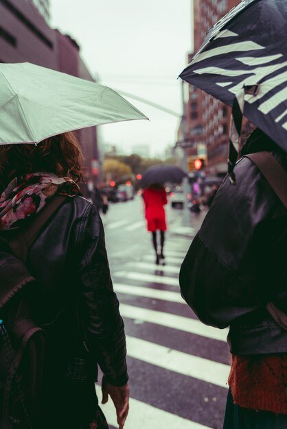 vertical-shot-group-people-walking-street-rain_181624-15698.jpg