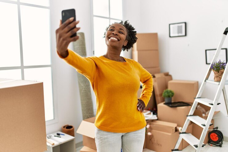 african-american-woman-make-selfie-by-smartphone-standing-new-home_839833-7326.jpg