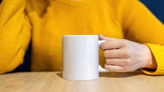 woman-sweater-holding-cup-wooden-table_1268-17080.jpg