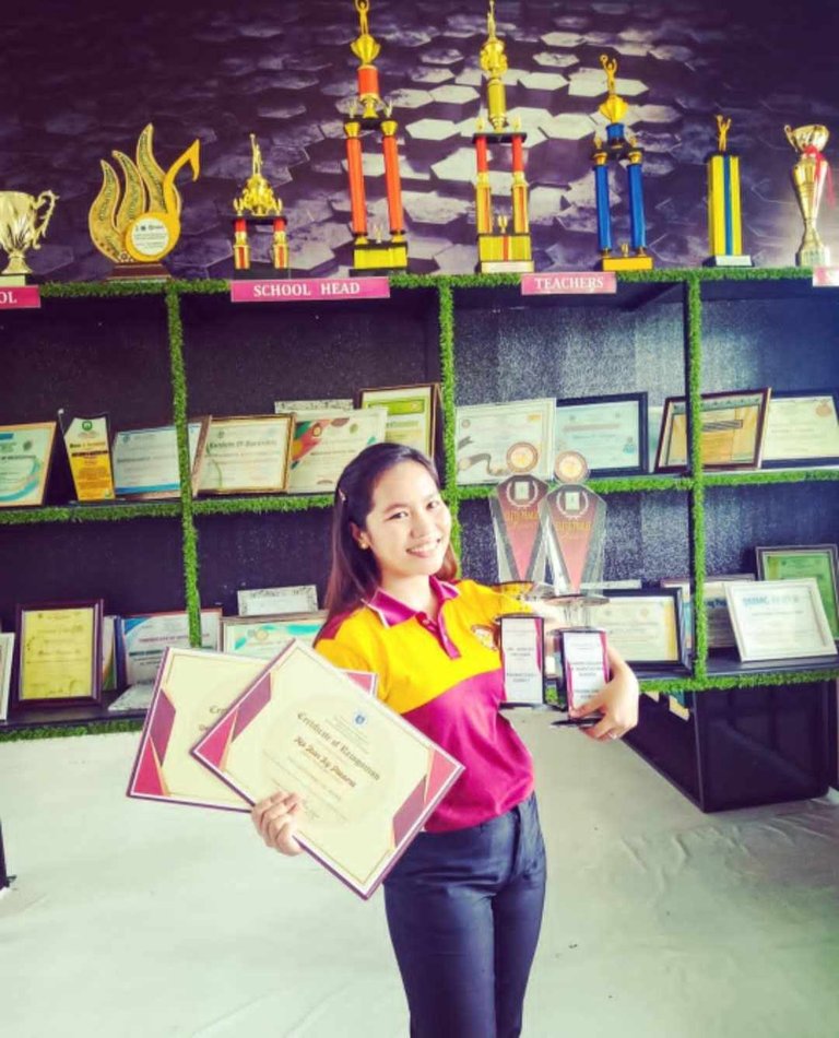 A winning smile as I receive my certificates and trophies as the Most Outstanding SSG Implementer and SSG Adviser of the DepEd Samar Division