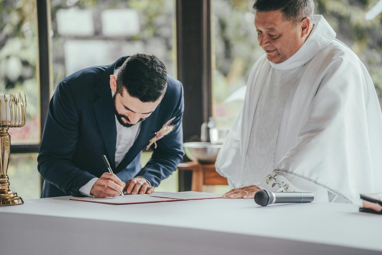 free-photo-of-groom-signing-marriage-license.jpeg