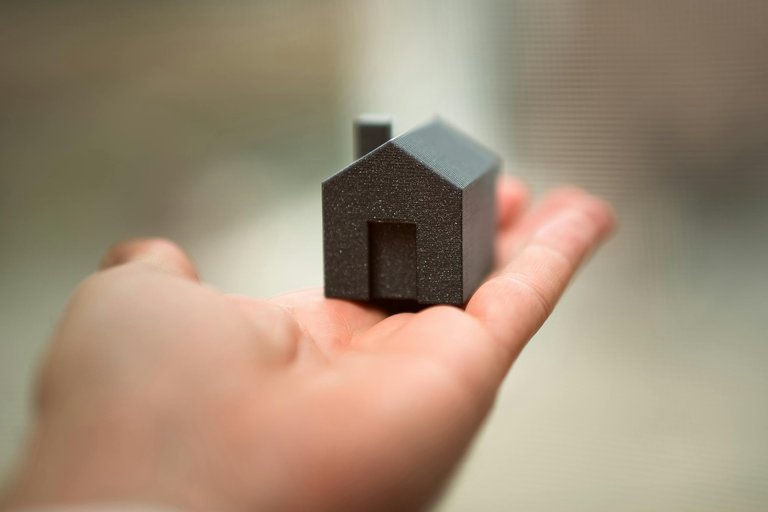 free-photo-of-hand-holding-small-model-house-symbolizing-real-estate.jpeg