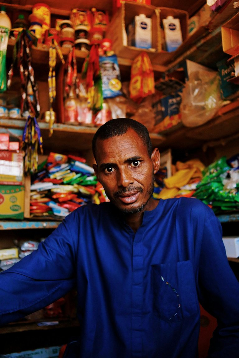 free-photo-of-portrait-of-a-shopkeeper-in-abuja-market.jpeg