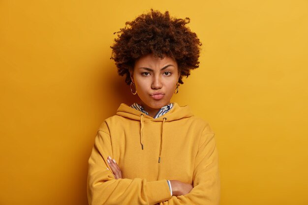 skeptic-angry-ethnic-woman-expresses-suspision-stands-with-arms-folded-pouts-lips-waits-explanations-being-angry-with-someone-wears-casual-clothes-isolated-yellow-wall_273609-37613.jpg