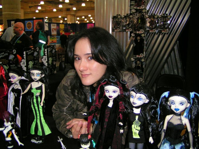 Amanda at Toy Fair with BeGoth dolls she had painted the night before.