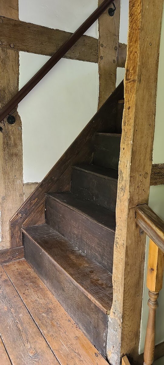 The rustic staircase leading to the bedrooms