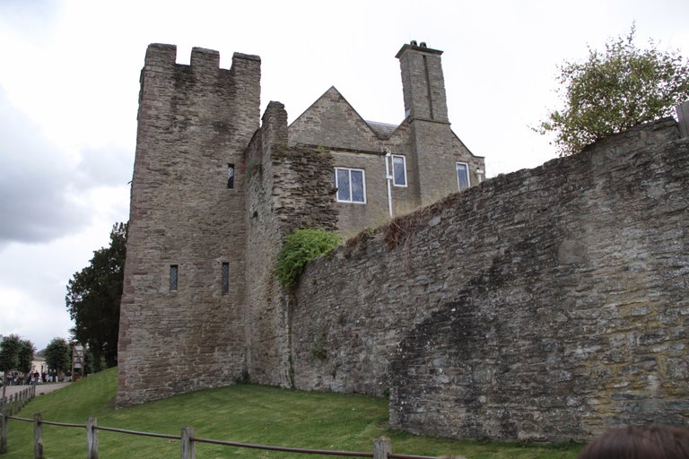A view of Ludlow castle from a sidewalk