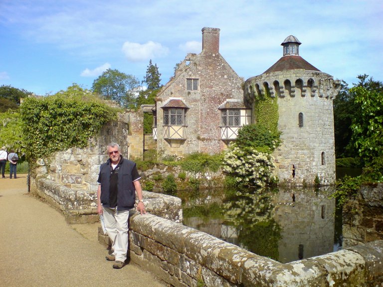 My father-in-law standing in from of some lovely building in UK