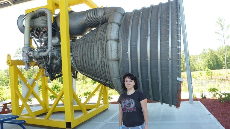 Amanda standing next to a rocket engine for size comparison