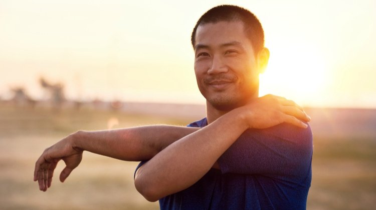 happy-man-stretching-arms-in-sunset.jpg