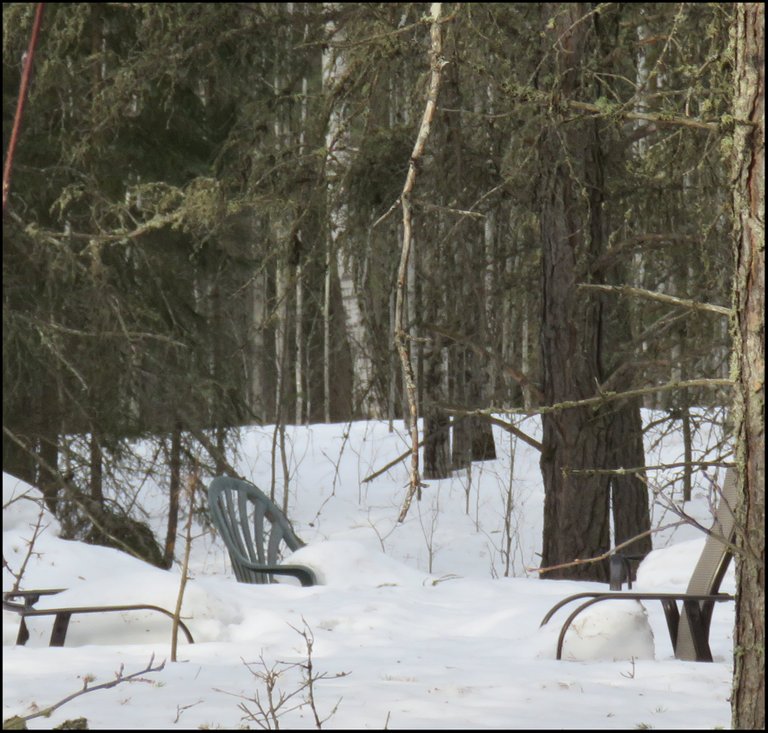 snowy scene of chairs by firepit.JPG