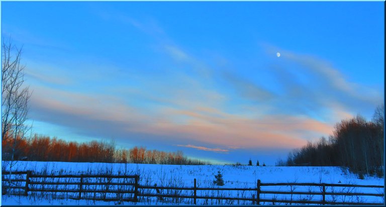 sunset on interesting cloud formation and moon above the snowy pasture.JPG