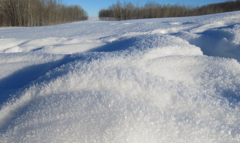 mounds of crystally snow on hilltop.JPG