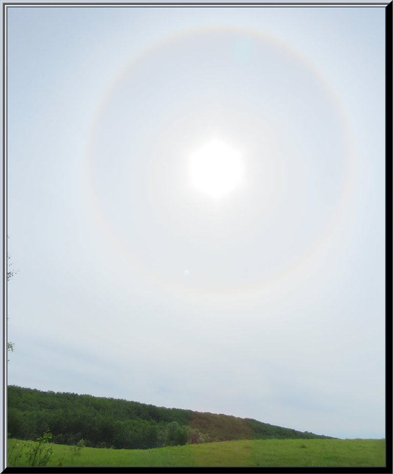 ring around sun above the hill tops.JPG