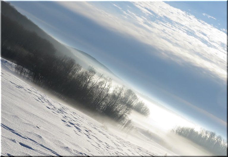 close up view of fog over lake and trees on hill.JPG