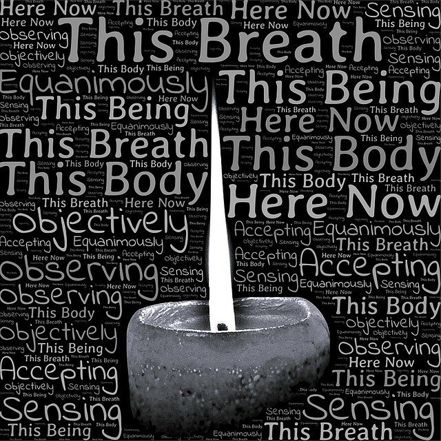 vipassana candle with words about being here now.jpg