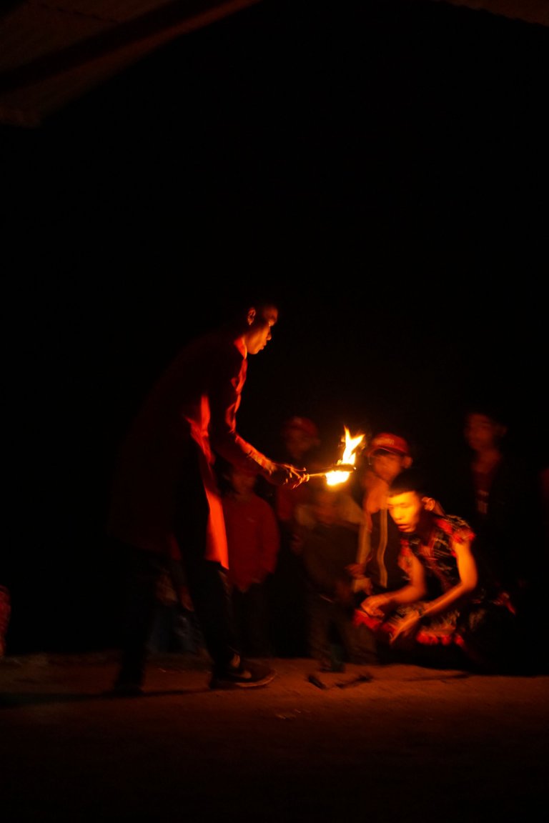 A young man is preparing for his fire dancing