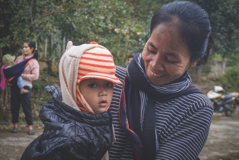 A woman holding her baby in her arms. Their smiles always make us feel happy