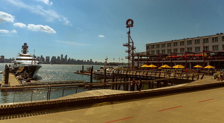 Standing at Shipyards seeing Lonsdale Quay Market and Downtown Vancouver across the water