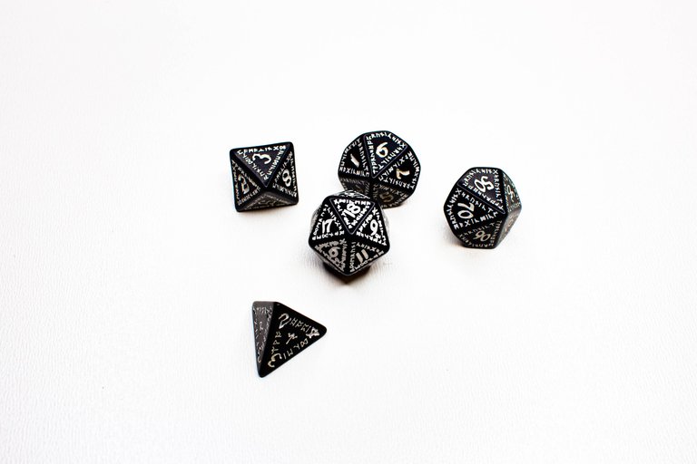 RPG dice in various shapes, runic on a white background, from the upper perspective.jpg