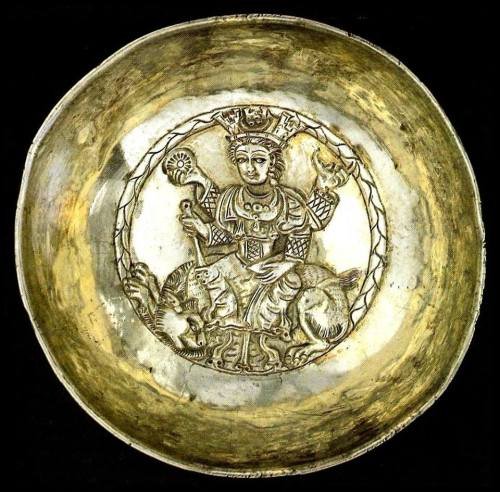 4th century Sasanian silver bowl with high-relief decoration showing deity Anahita sitting on a lion and holding sun in her right hand.