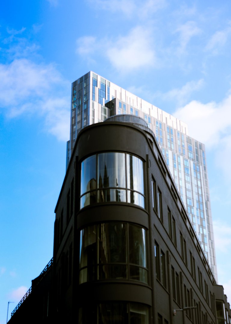 round corner building with a tall skyscraper in the background.jpg