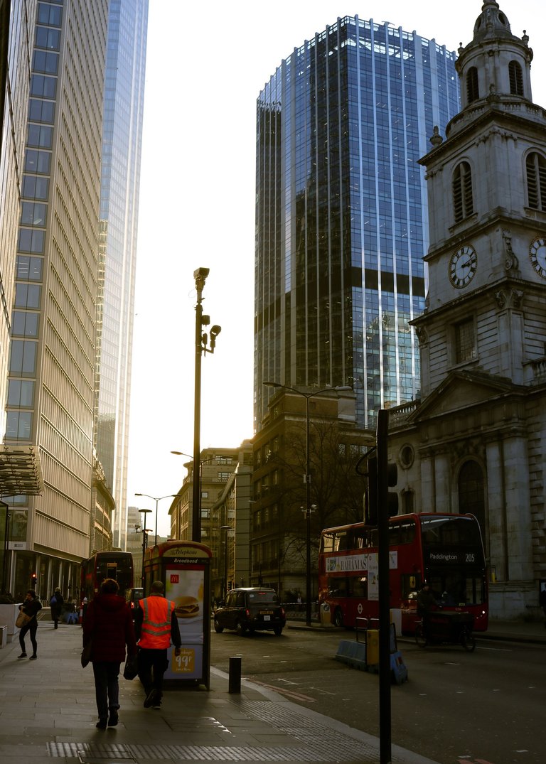 golden hour between buildings with people and double decker.jpg