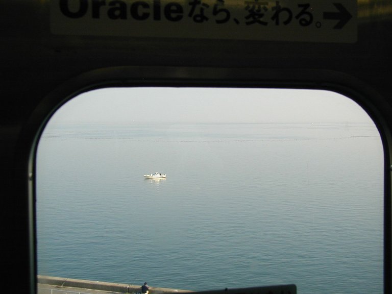 169 - Boat in Tokyo Harbor catching some stuff for Tsukiji. (Taken on train going to the Tokyo Motor Show 2005, featured on the Cars page).